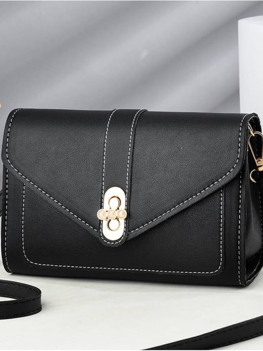 Elegant Black Crossbody Bag with Gold Accents